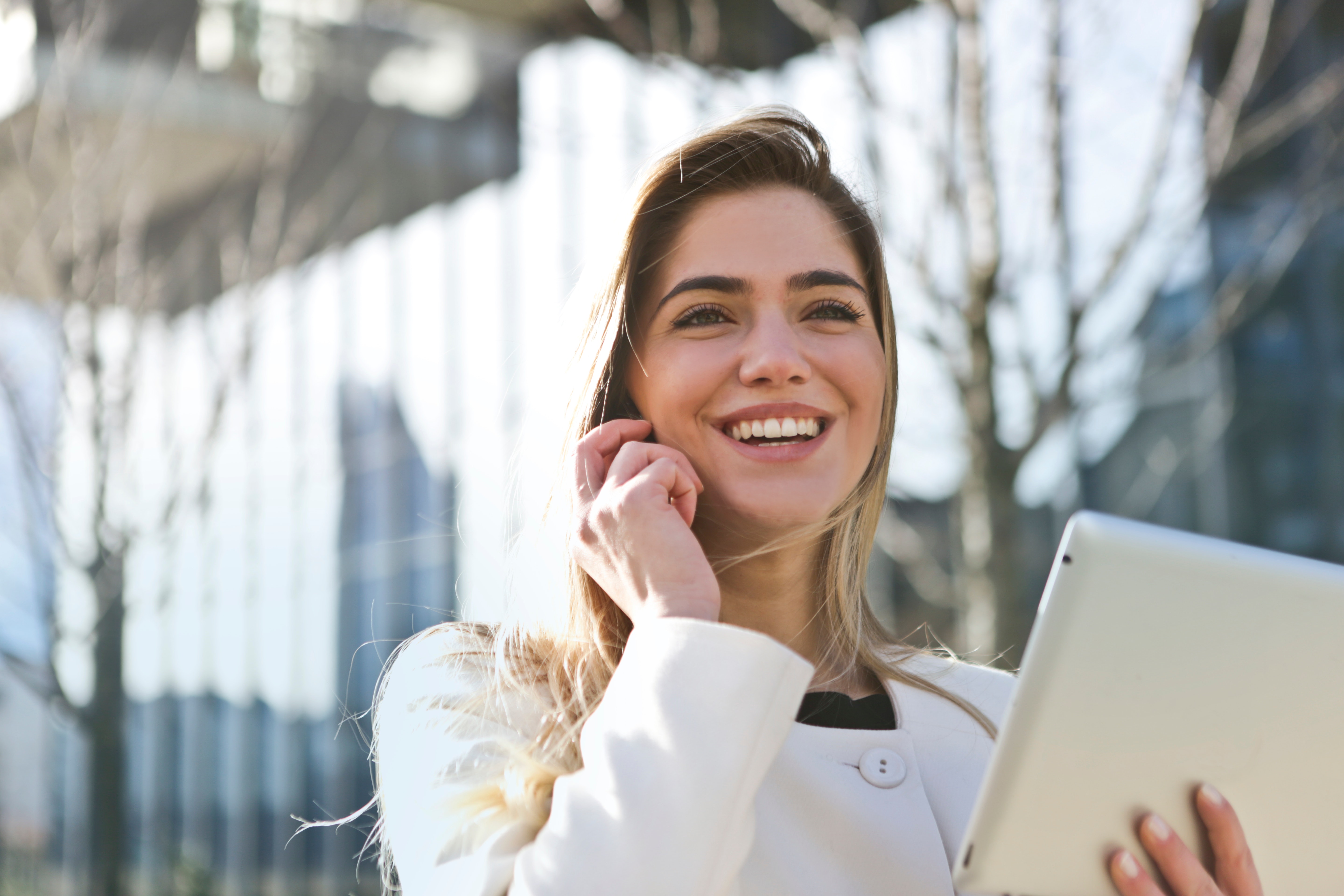 woman smiling tablet in hand