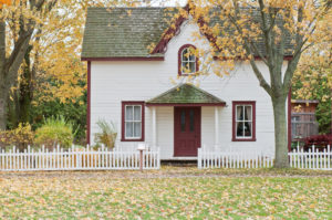 White and Red Wooden House With A Fence