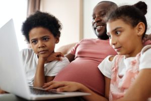 family-looking-at-a-laptop-laughing