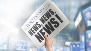Person holding up a newspaper