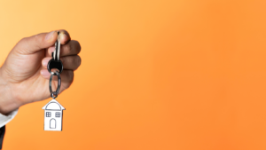 Hand holding a key to new house