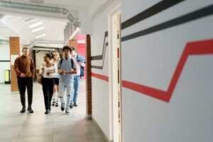 high school students walking down a hallway to a financial planning class