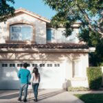 home owners thinking about Home Maintenance Checklist in driveway