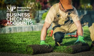 Man rolling out turf with text "Business Checking Accounts"