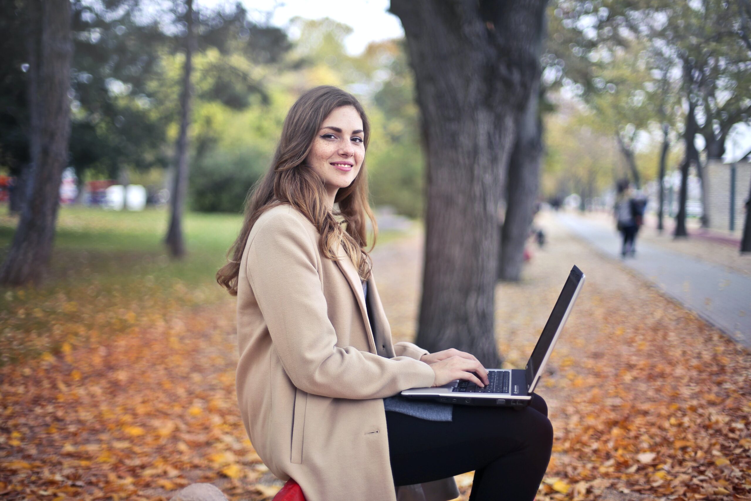 women at park on laptop learning about budgeting